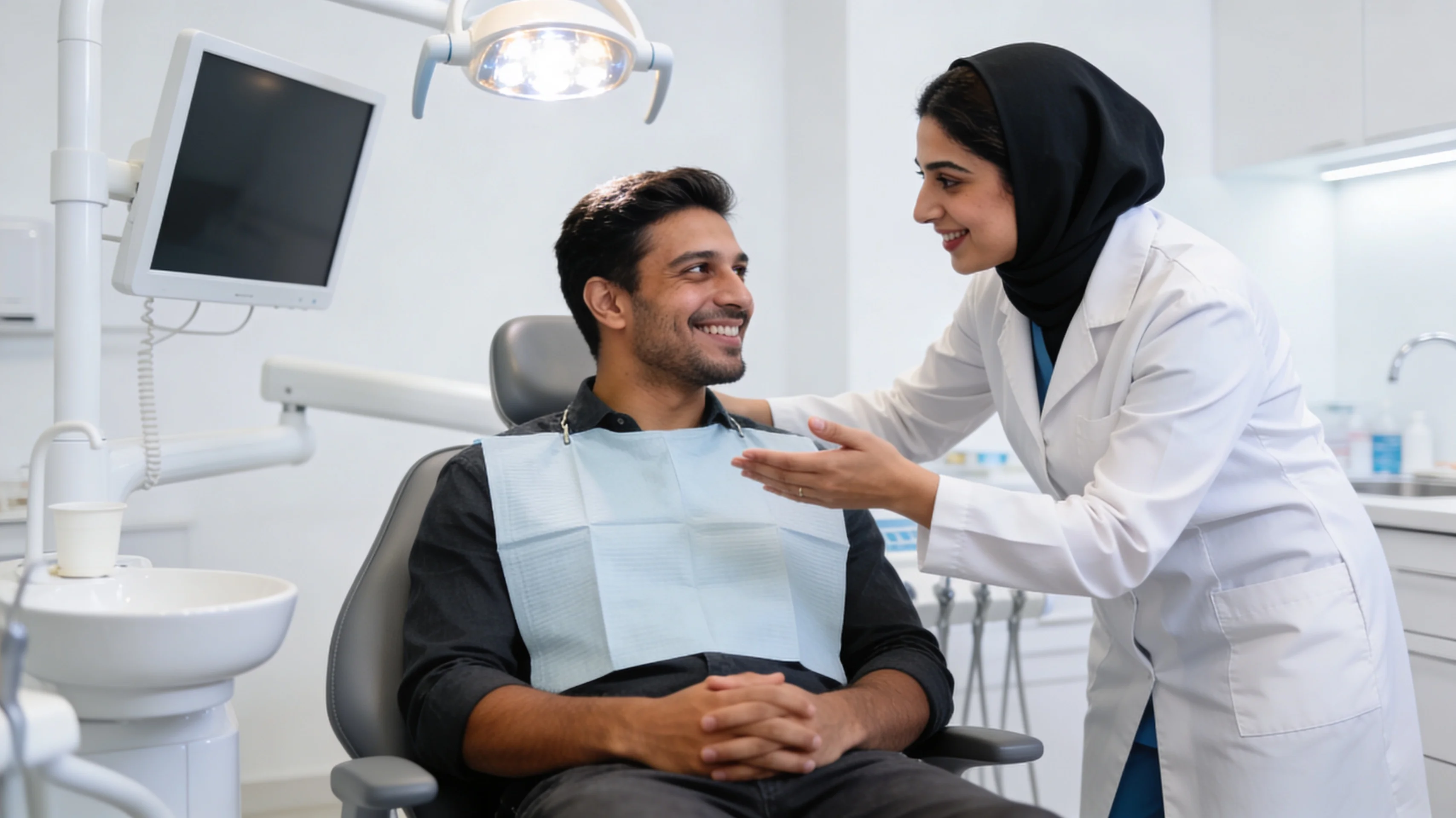 Dentist consulting warmly with patient